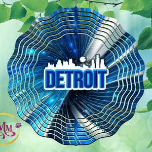 May include: A blue and silver metal wind spinner with a cityscape silhouette and the word "DETROIT" in blue letters.