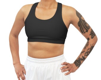May include: A black sports bra with a racerback design. The bra is made of a stretchy, comfortable material and has a wide band around the bottom.