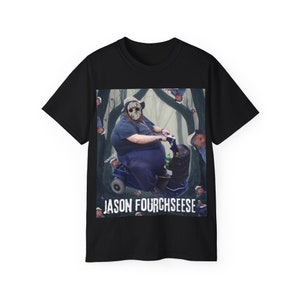 May include: Black t-shirt with a graphic of a person wearing a hockey mask and riding a mobility scooter in a forest. The text "Jason Fourchseese" is printed below the graphic.