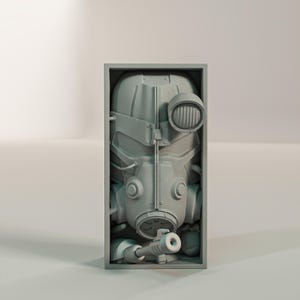 May include: A gray, detailed sculpture of a gas mask and helmet, encased in a rectangular frame. The mask features a prominent circular light and a nozzle. The overall design suggests a post-apocalyptic or sci-fi theme.