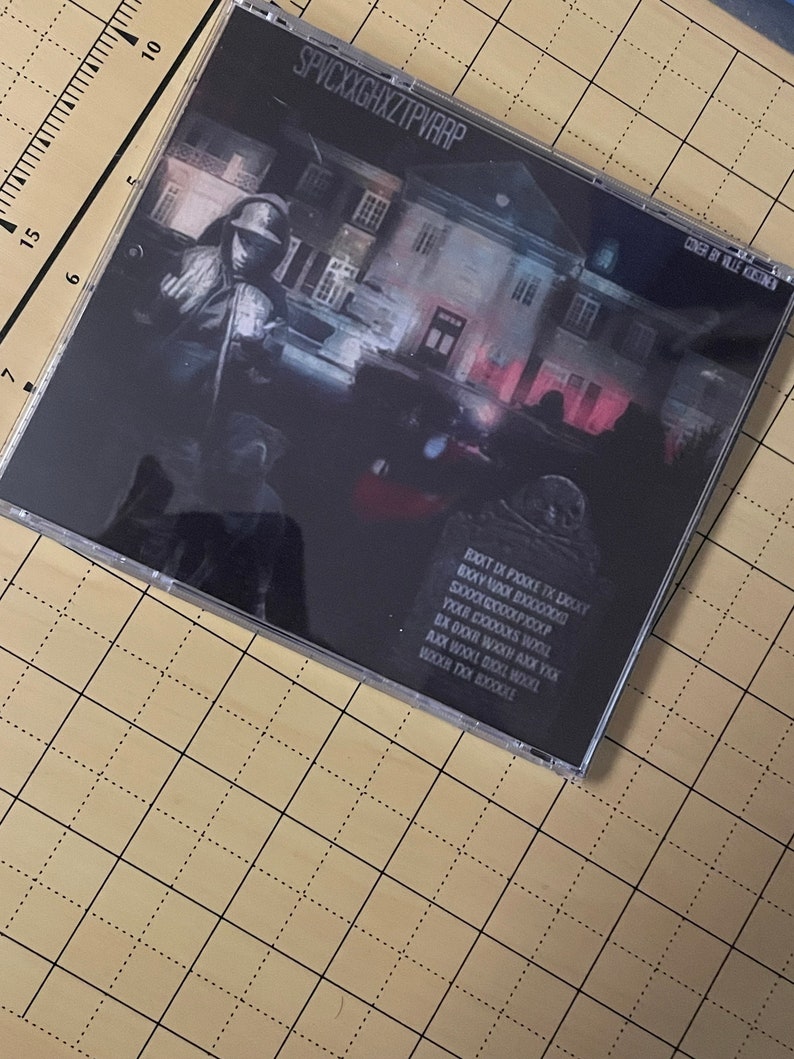May include: A black CD case with a white and red house on the front. The title "SPVCXXGHXZTPVRRP" is printed in white on the front of the case. The text "CONGER BY VILLE KOSTINE" is printed in white on the right side of the case. The back of the case has black text on a black background.