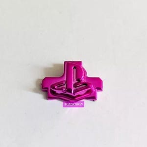 May include: A pink PlayStation button replacement featuring the PlayStation logo in a raised design.