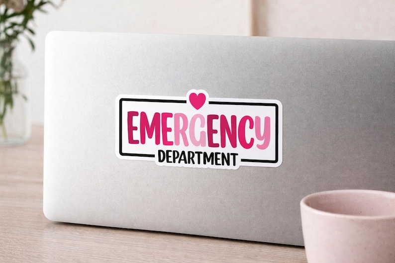 May include: A rectangular sticker with the words "EMERGENCY DEPARTMENT" in pink and white, with a pink heart above the word "EMERGENCY". The sticker has a black border and is on a silver laptop.