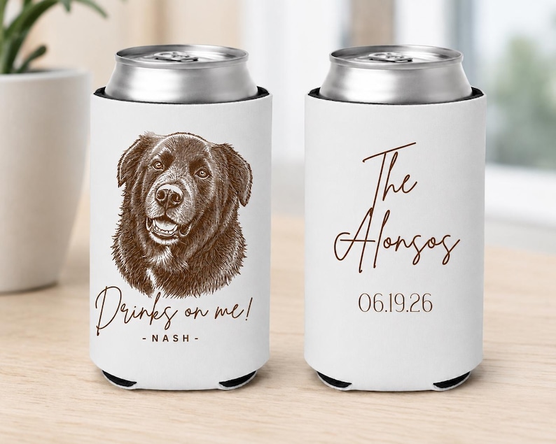 May include: Two white foam can coolers with brown ink designs. One features a brown sketch of a dog with the text "Drinks on me! - NASH -". The other displays the text "The Alonsos" in script above the date "06.19.26" in a simple brown font.