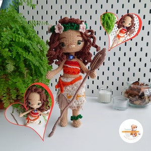 May include: A handmade crochet doll depicting a character with brown curly hair, wearing an orange and white top, and a beige skirt. The doll holds a spear and has a flower crown. The doll is approximately 10 inches tall.