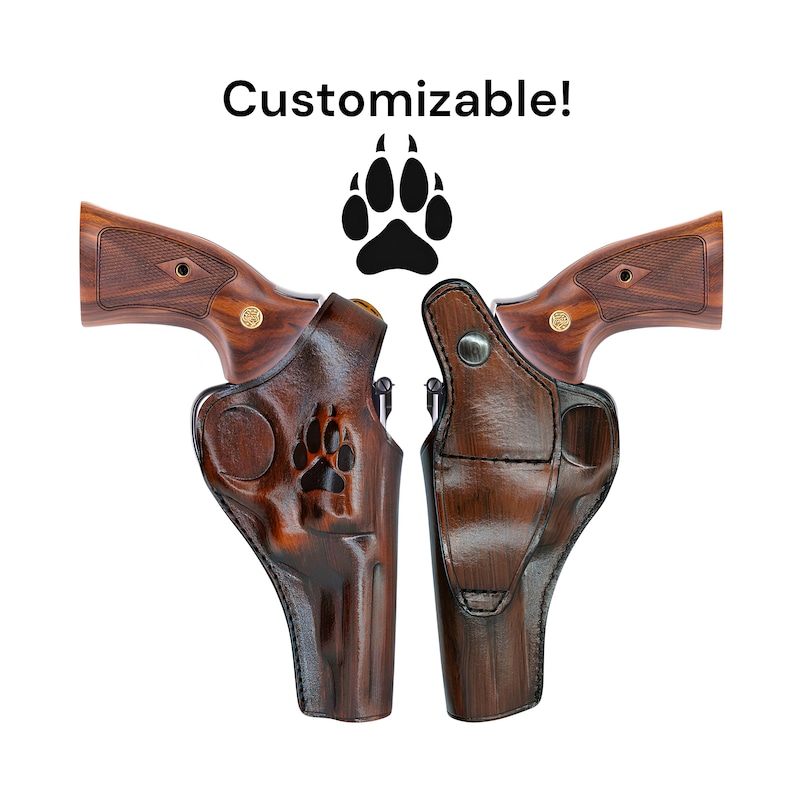 May include: Two brown leather gun holsters with a paw print design, displayed side-by-side. The holsters are set against a white background. The text "Customizable!" is above the holsters.