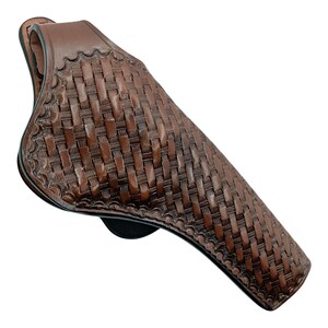 Puede incluir: Una funda de cuero marr&oacute;n con un patr&oacute;n de tejido de cesta. La funda tiene una forma curva y un lazo para un cintur&oacute;n. Los bordes est&aacute;n decorados con un dise&ntilde;o floral.