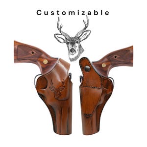 May include: Two brown leather gun holsters with a deer head design, paired with two revolvers with wooden handles. The word "Customizable" is printed above the holsters. The holsters are designed to fit the revolvers.