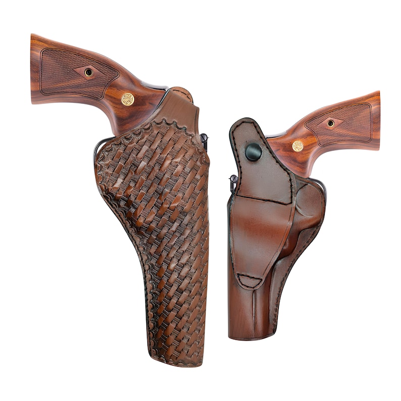 May include: Two brown leather gun holsters with wooden handles. One holster has a woven pattern, the other is smooth. The revolvers have wooden grips and gold accents. The holsters are designed to carry a handgun.