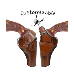 May include: Two brown leather holsters with a scorpion design, each holding a revolver with a wooden grip. The word "customizable" is written above the holsters. The holsters are designed to fit the revolvers.