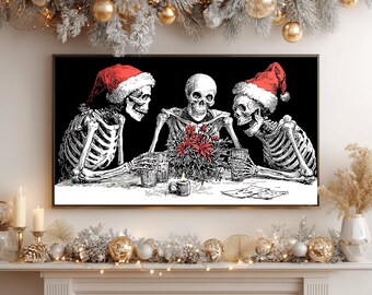 May include: A rectangular wall art print featuring three skeletons sitting at a table. Two skeletons wear red Santa hats. They are gathered around a central arrangement of red poinsettia flowers and a small candle, with glasses in their hands.