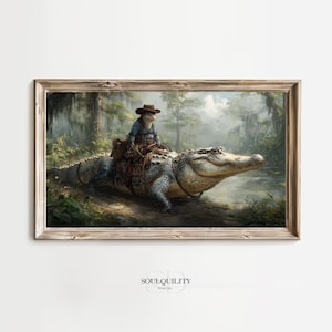 Puede incluir: Una impresión artística enmarcada representa a un vaquero montando un caimán a través de un pantano. El caimán es gris y amarillo, con una silla de montar. El vaquero es un animal pequeño que lleva un sombrero y una camisa azul. El fondo presenta árboles y agua.