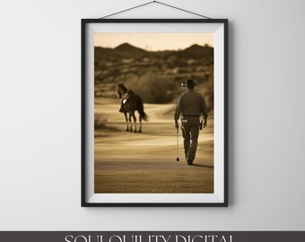 May include: A sepia-toned framed wall art print depicting a person wearing a cowboy hat and long pants walking away across a field while holding a golf club, with a horse standing in the distance against a backdrop of rolling hills.