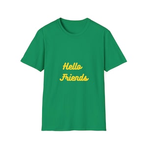 May include: A green t-shirt with the words "Hello Friends" in yellow script. The shirt is a solid green color and has a crew neck. The text is centered on the front of the shirt.