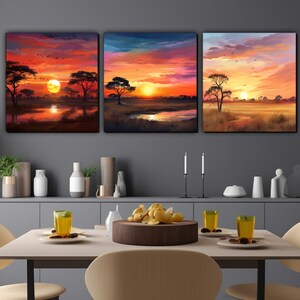 May include: Three sunset landscape paintings with a red, orange, and yellow sky. The paintings feature silhouetted trees and a lake in the foreground.