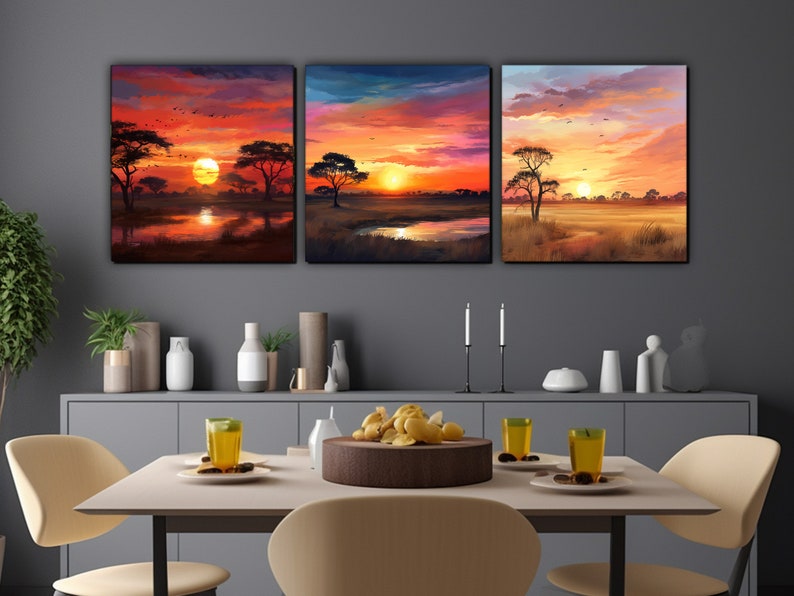 May include: Three sunset landscape paintings with a red, orange, and yellow sky. The paintings feature silhouetted trees and a lake in the foreground.