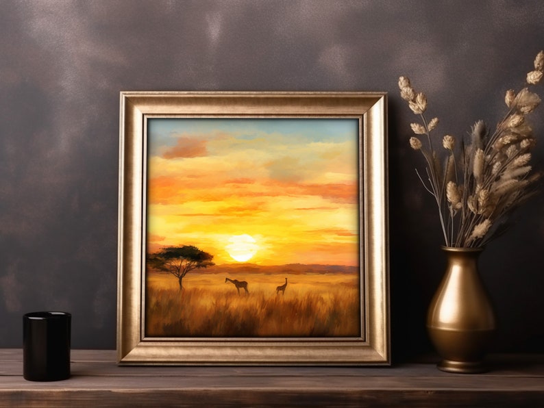 May include: A framed painting of a sunset over a savanna with two giraffes in the foreground. The painting is in a gold frame and is hanging on a brown wall.