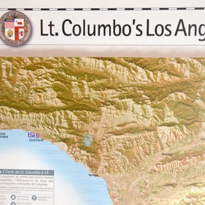 May include: A map of Los Angeles, California, with the title "Lt. Columbo's Los Angeles map." The map shows the different locations of crimes and events related to Columbo's television show. The map is in a vintage style with a yellow and brown color scheme.