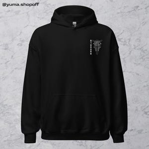 May include: Black hooded sweatshirt with a white graphic of a motorcycle and the word "SIDOOOR" on the front.