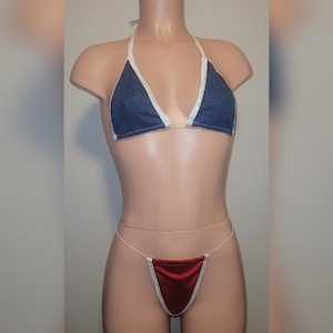 May include: A denim bikini top with white trim and a matching red velvet bikini bottom with white trim.