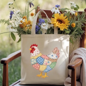 May include: A beige tote bag featuring a colorful patchwork chicken design. The bag is filled with a bouquet of wildflowers, including sunflowers, daisies, and other greenery. The bag is sitting on a wooden chair.