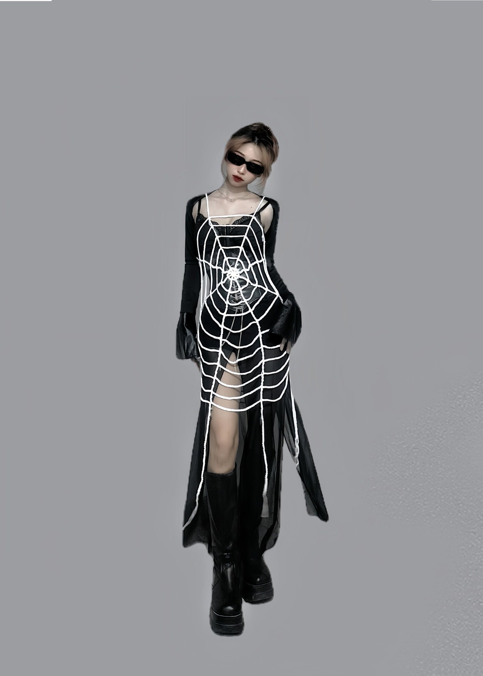 Black mesh cover-up with white crochet spiderweb detail across the front, long flared sleeves, and sheer floor-length skirt with center slit.