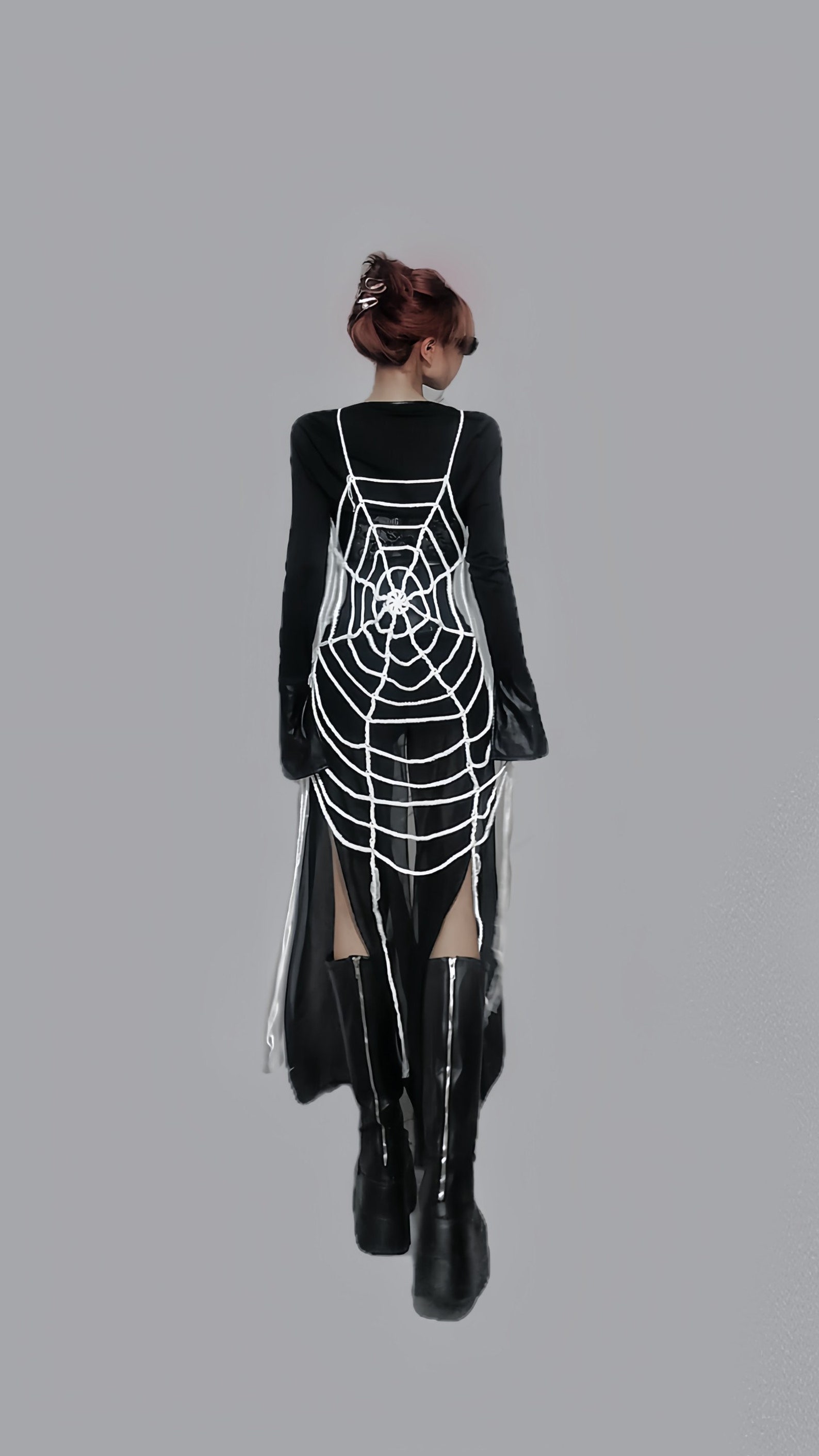 Back view of black mesh cover-up with white crochet spiderweb detail, full-length sheer skirt, long sleeves, and dual side slits.