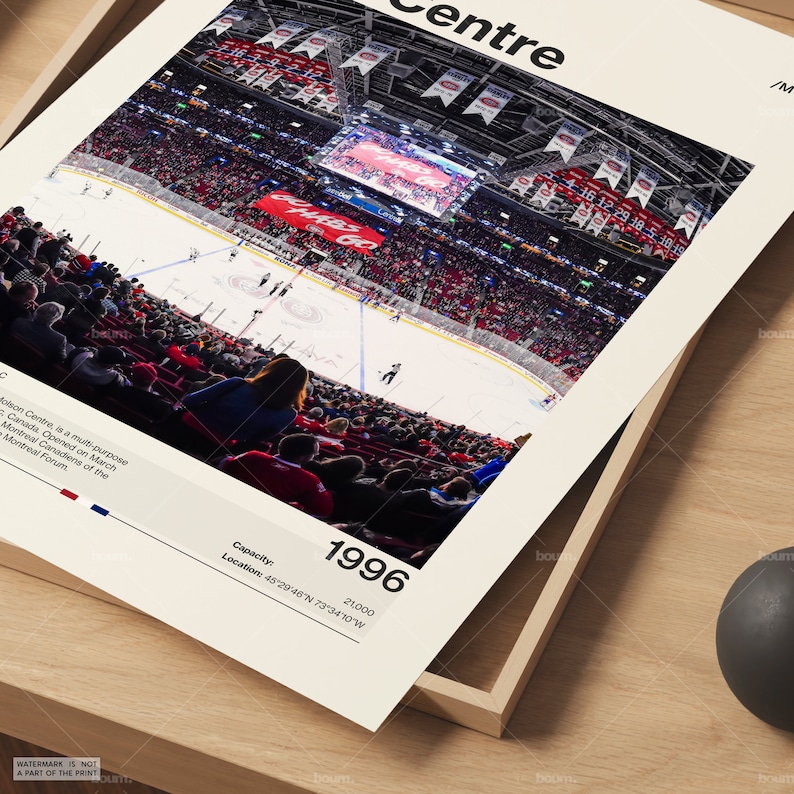 May include: A framed print featuring an aerial view of a hockey game at the Molson Centre in Montreal, Canada. The arena is filled with spectators in red seating. The print includes the year 1996, capacity 21,000, and location coordinates.