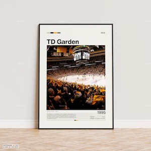 May include: A framed poster featuring the TD Garden arena in Boston, Massachusetts. The image shows a hockey game in progress, with a packed crowd and the text "TD Garden" at the top. The year "1995" is also displayed.
