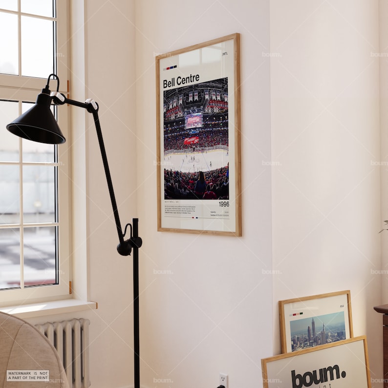 May include: A framed poster featuring the Bell Centre arena with the text "Bell Centre" at the top. The image shows a hockey game in progress, with the year "1996" at the bottom. The frame is a light wood color.