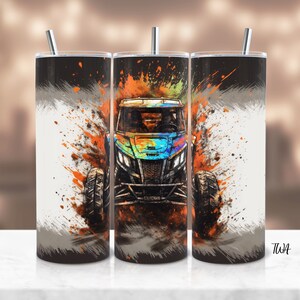 May include: A black and white tumbler featuring a colourful graphic of an off-road vehicle driving through a splash of orange and yellow paint.