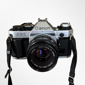 Cámara de cine Canon AE-1 Program de 35 mm, modelo clásico, con objetivo de 50 mm f/1.8, revisada y lista para usar.