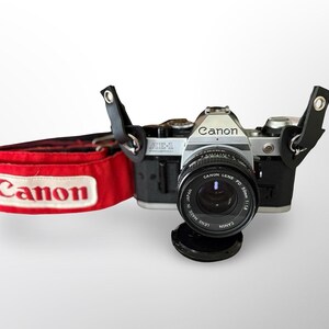 Cámara de cine Canon AE-1 Program de 35 mm, modelo clásico, con objetivo de 50 mm f/1.8, revisada y lista para usar.