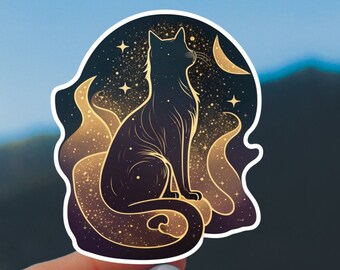 May include: A sticker featuring a black cat silhouette with a starry night sky design. The cat is seated, with a crescent moon and stars in the background. The sticker has a gold and purple color scheme, with a white border.