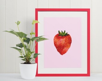 May include: A framed print of a red strawberry on a pink background. The frame is red and the print is in a white mat.