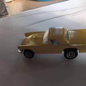 Hot Wheels Yellow &#39;57 Chevrolet Bel Air diecast car. .