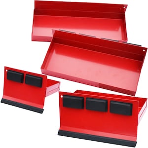 May include: Several red metal magnetic trays with black rubber strips and black magnets. The trays are rectangular with a lip on one side and are designed to hold tools or small parts. The trays are shown from different angles.