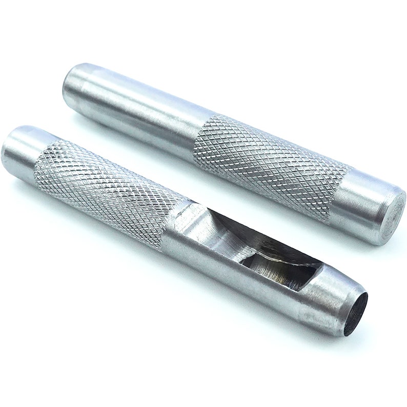 May include: Two silver metal leather hole punch tools with a textured grip. The tools are designed to punch holes in leather for crafts and projects.