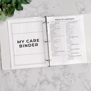 May include: A white binder with the text "MY CARE BINDER" on the left page and a detailed table of contents on the right. The table includes sections for medical management, daily living, and insurance policies.