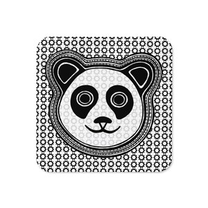 May include: A square coaster featuring a stylized black and white panda face illustration centered on a background of repeating small black gear icons. The panda has large circular eyes, a small nose, and a curved mouth, all outlined in black.