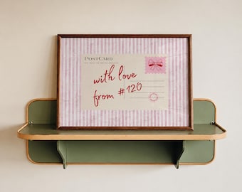 May include: A framed print featuring a postcard design with a pink and white vertical striped background. The postcard text reads "POSTCARD" and "with love from #120" in red script, with a pink bow stamp graphic in the top right corner.