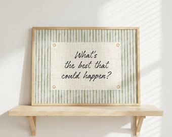 May include: A framed print with the text "What's the best that could happen?" The print has a light green and white striped background and a beige center. The frame is a light wood color. The print is displayed on a wooden shelf.