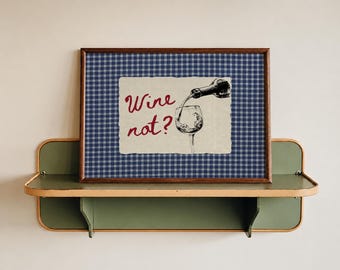 May include: A rectangular framed print featuring a blue and white checkered background. Centered is a cream-colored rectangular insert with a black ink illustration of a wine bottle pouring into a glass, accompanied by the red text Wine not?