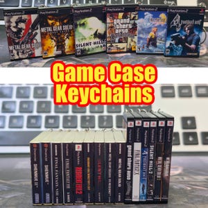 May include: Miniature game case keychains featuring popular PlayStation 2 and Dreamcast titles like Metal Gear Solid, Silent Hill, and Grand Theft Auto. The keychains are arranged on a keyboard, with the text "Game Case Keychains" in the center.