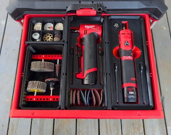 May include: Red tool box with two Milwaukee FUEL cordless power tools, one with a grinding wheel and one with a sanding disc, and a variety of sanding discs and grinding wheels.