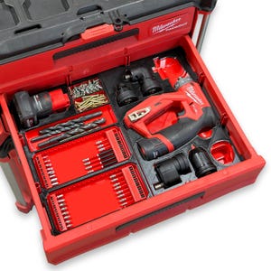 May include: Open red toolbox drawer filled with various power tools and accessories. Includes a red and black drill, drill bits, screws, and other attachments. The toolbox is labeled "Milwaukee PACKOUT".