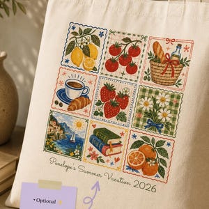 May include: A cream-colored canvas tote bag featuring a grid of nine colorful illustrations including lemons, tomatoes, a picnic basket, coffee, strawberries, daisies, a coastal landscape, books, and oranges, with the text Penelope's Summer Vacation 2026.