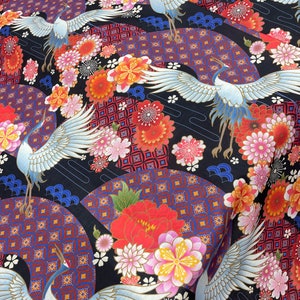 May include: Black fabric with a repeating pattern of white cranes, red and pink flowers, and blue and red geometric designs.