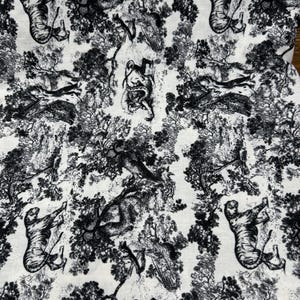 May include: Black and white toile fabric featuring a repeating pattern of tigers, figures, and foliage. The detailed design includes trees, animals, and human-like figures, creating a classic, decorative aesthetic. The fabric is suitable for various sewing and crafting projects.