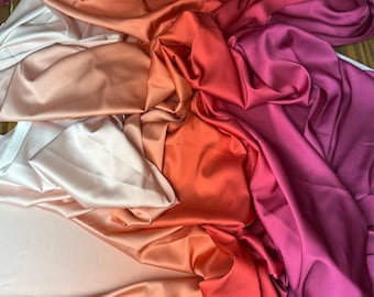 May include: A collection of draped fabric in a variety of colors, including white, peach, orange, red, and magenta. The fabric has a smooth, satin-like texture, with folds and shadows creating depth and dimension.